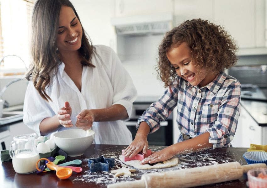 Shot of an adorable little girl baking with her mom at home.