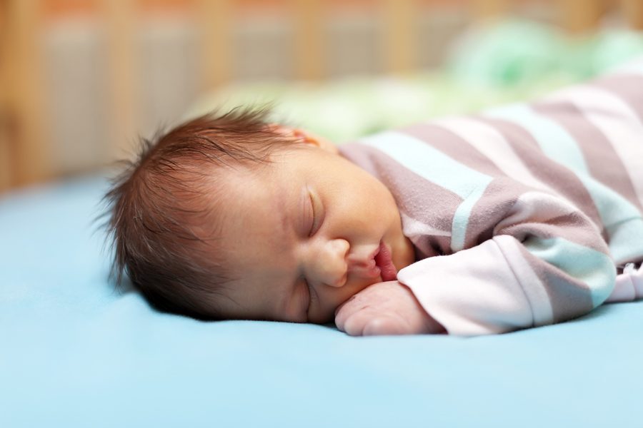 newborn baby sleeps in crib
