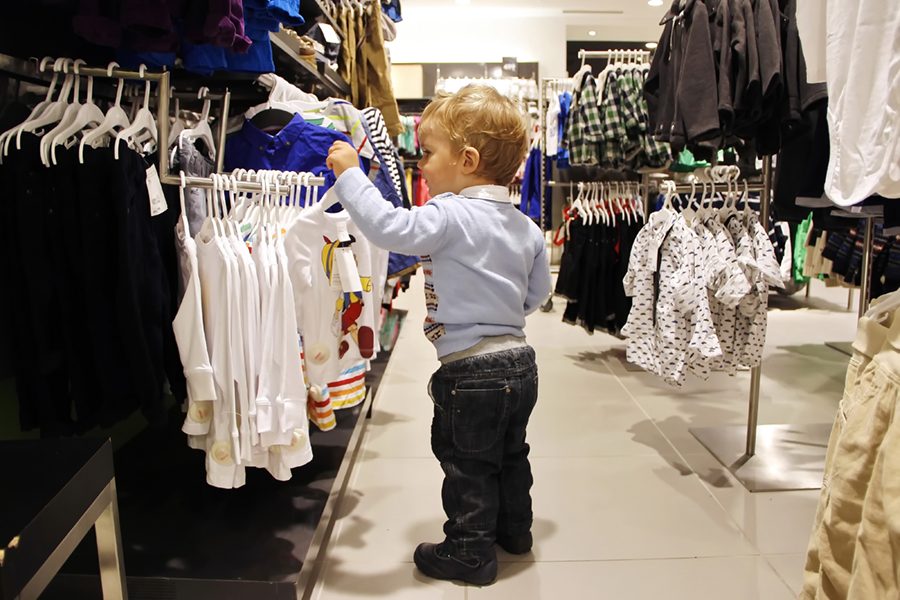 Child chooses clothes in store