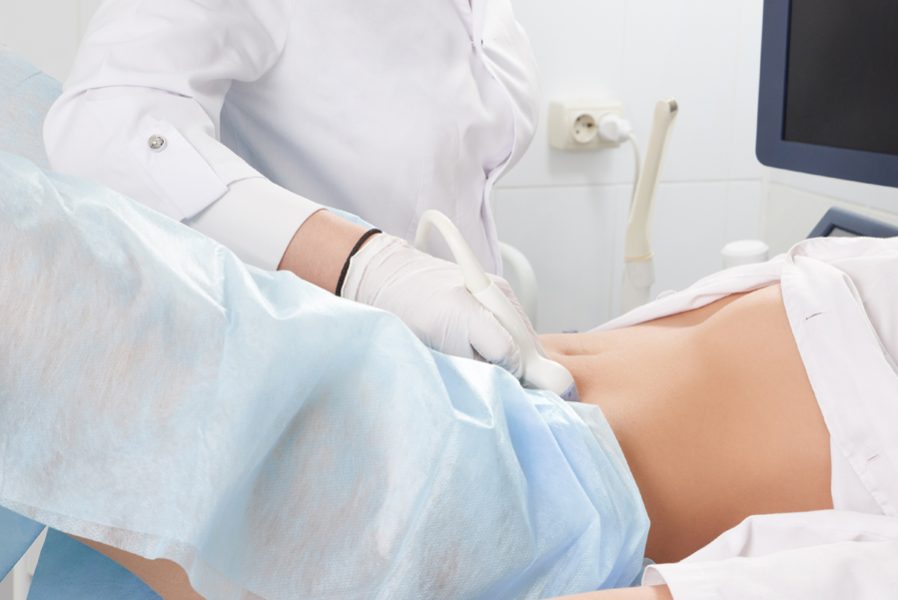 Cropped view of woman at gynecologist's doing ultrasound scan of the lower part