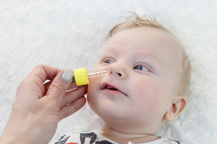 cute baby gets nose drops