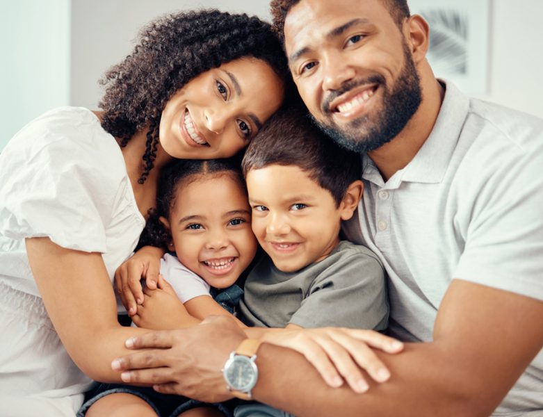 Man, woman and children in family portrait hug and bonding on house living room sofa or home interior furniture. Happy smile, love couple or mother and father with kids in trust, security and support.