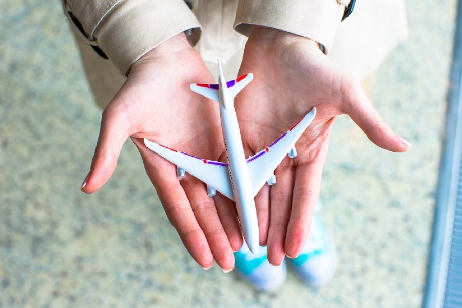 Close up hand holding an airplane model