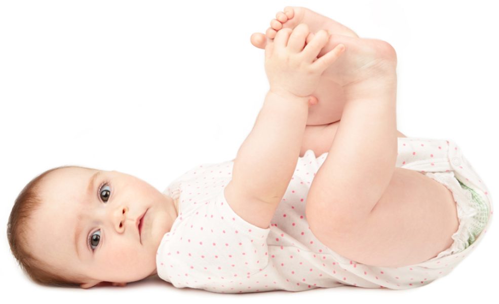 Happy baby playing with his feet isolated on white background. Top view