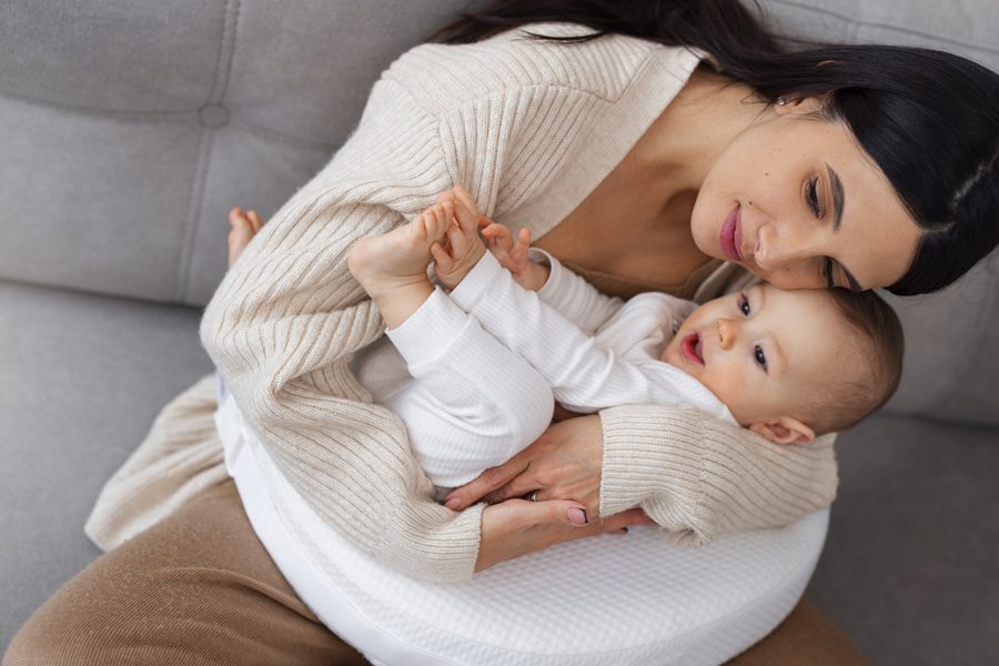 high-angle-mother-holding-newborn-baby