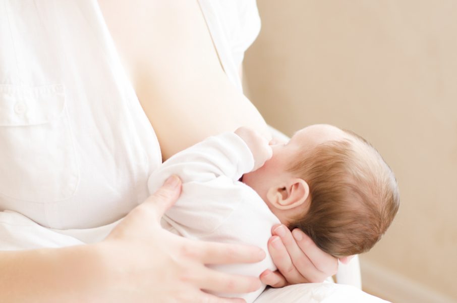 Baby eating breast milk. Mother breastfeeding her baby boy. Concept of lactation.