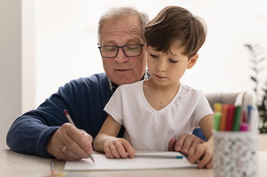 little-boy-doing-homework-with-his-grandmother
