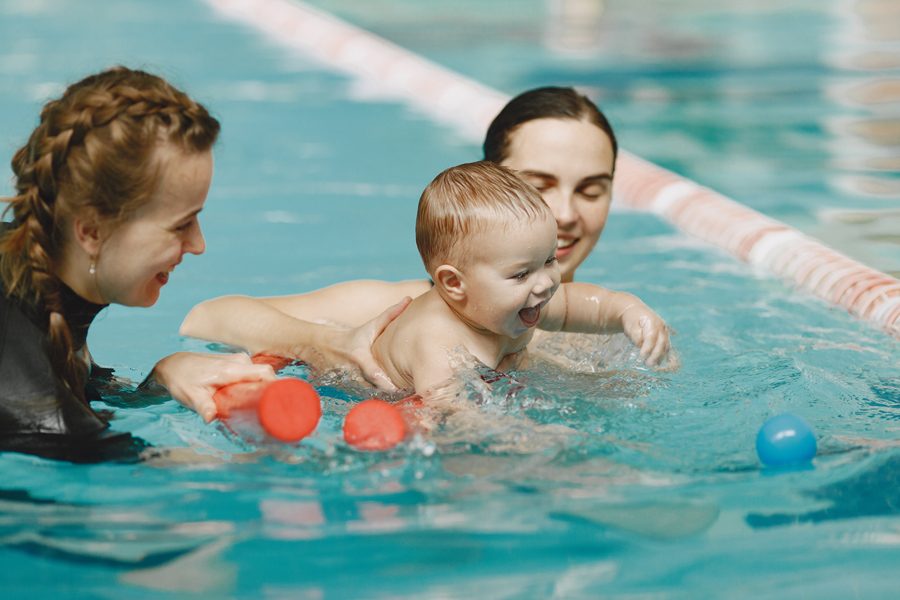 Little cute baby boy. Instructor with kid. Mother with son.