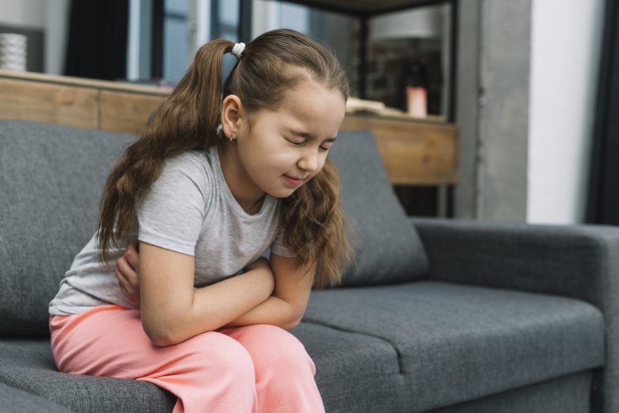 little-girl-holding-hands-her-stomach-suffering-from-pain