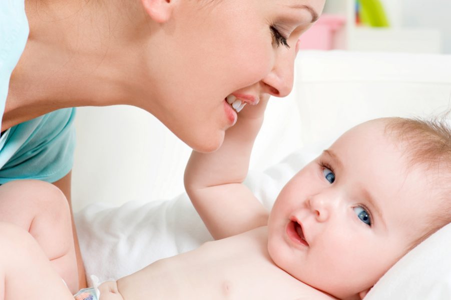 Closeup faces of young happy mother with cute newborn baby