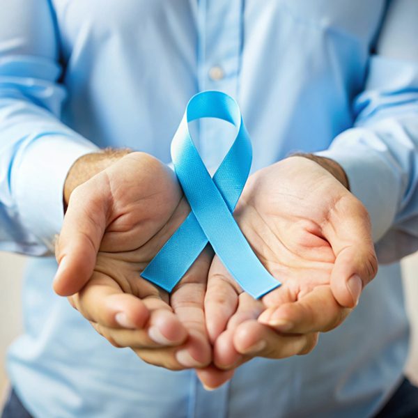 Male hands holding prostate cancer awareness ribbon