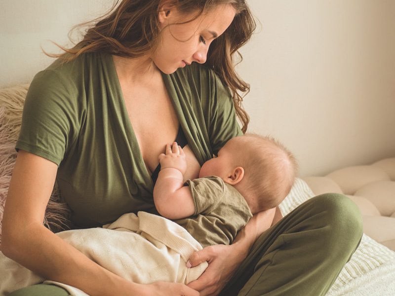 The concept of breastfeeding. Portrait of mom and breastfeeding baby.