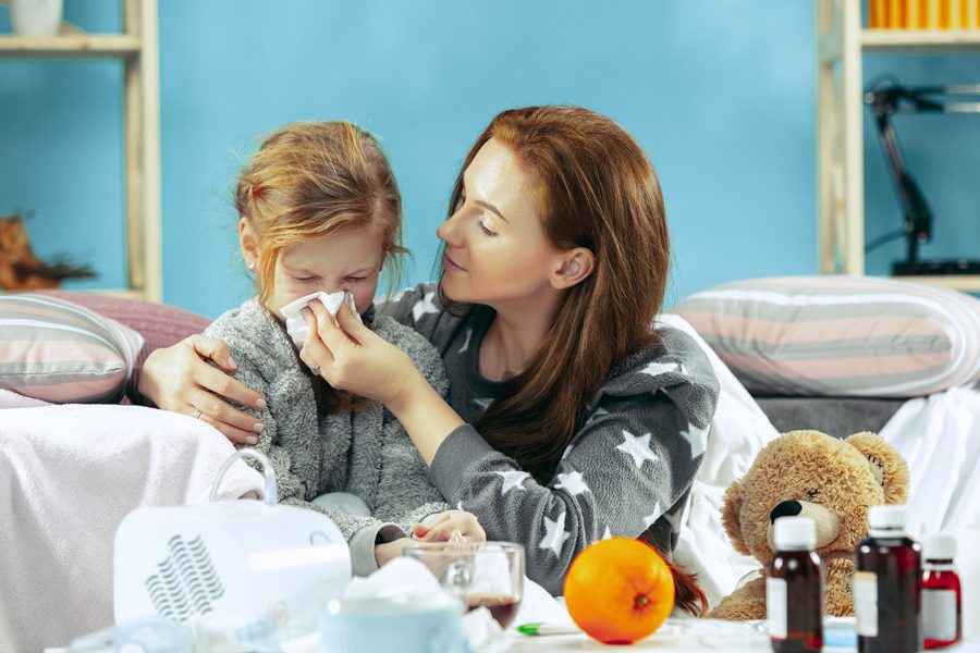 Sick woman with daughter at home. Home Treatment. Fighting with a desease. Medical healthcare. Family iIlness. The winter, influenza, health, pain, parenthood, relationship concept. Relaxation at Home