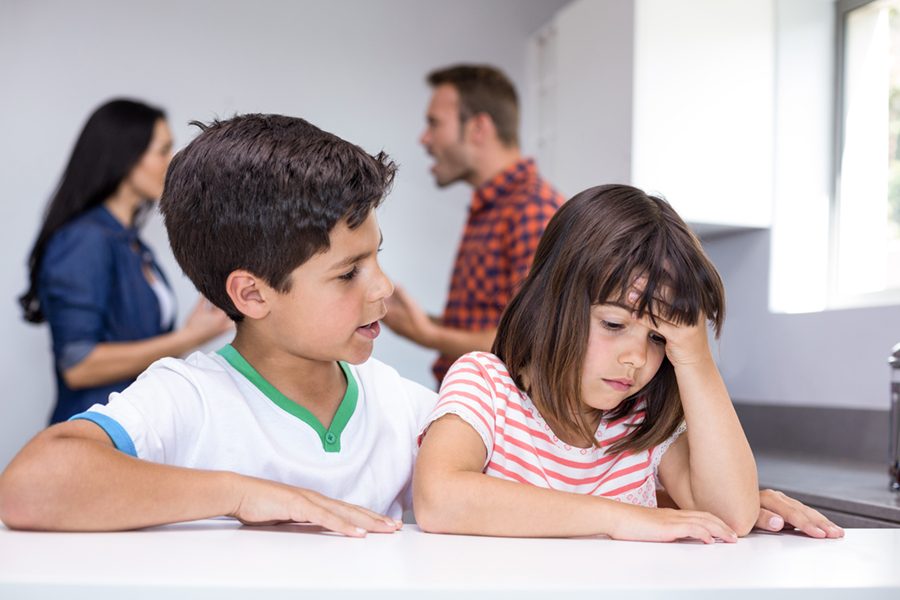 Parents arguing in front of children in the kitchen