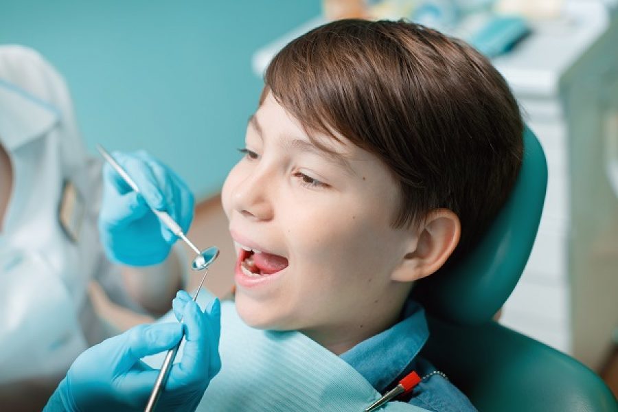 patient-dental-chair-teen-boy-having-dental-treatment-dentists-office 2