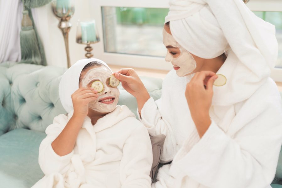 Photo of mother and daughter in white bathrobes.