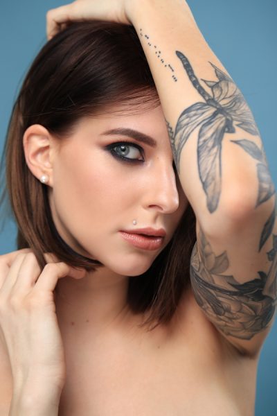 Beautiful woman with tattoo on a hand