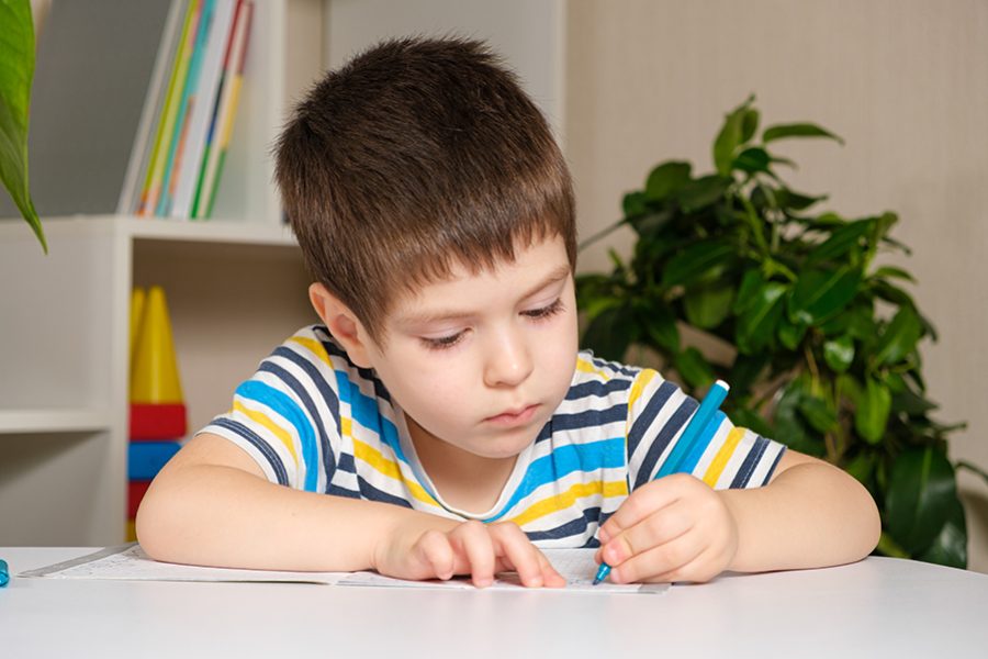 Preschool child learns to write, writes copybook