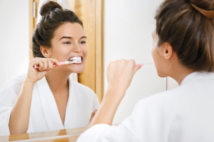 Woman cleaning her teeth in the bathroom