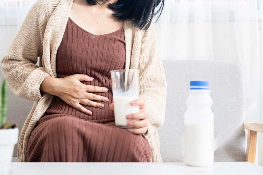 woman-having-stomachache-after-drinking-milk-rd